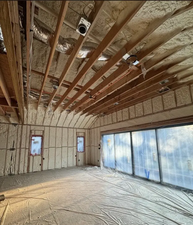 Interior walls and ceiling insulated with spray foam during new construction in Newcastle